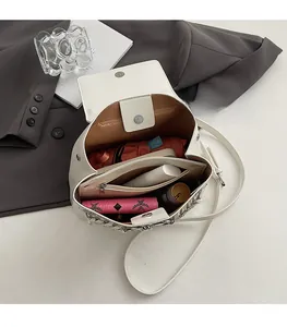 Top view of white leather crossbody bag interior showing spacious compartments and storage