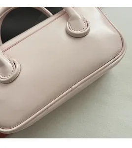 Détail du sac boston en similicuir rose clair avec logo Clear Heart argenté imprimé