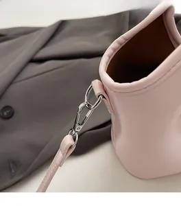Detail of pink leather handbag showing high-quality silver swivel metal clasp and strap