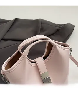 Top view of pink leather bucket bag showing dual handles and secure metal buckle detail