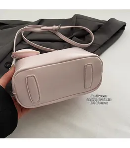 Close-up of pink bucket bag base featuring protective wear-resistant bottom pads