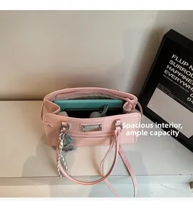 Interior view of large capacity pink shoulder bag showing main compartment and zipper pocket