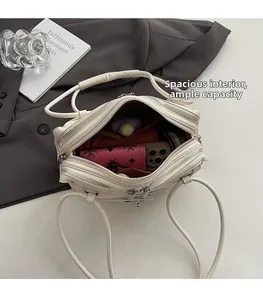 Overhead view showing spacious dual-zipper compartments of the white leather shoulder bag