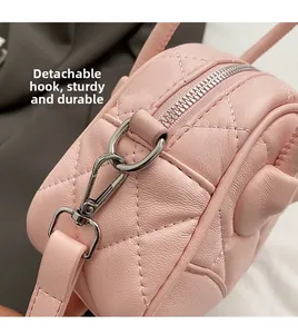 Detail of pink quilted leather bag with high-quality metal zipper and detachable hook strap