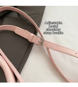 Detail of pink leather shoulder strap with adjustable silver buckle and precise stitching