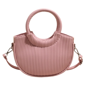 Pink crescent handbag with vertical pleated texture and round handle on white background