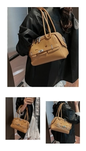 Detail of khaki leather shoulder bag showing the silver twist lock and slim handles