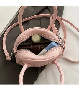 Internal view of pink quilted boston bag showing spacious storage for makeup and wallet