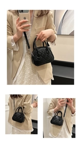 Detail of black quilted shell handbag with silver hardware and adjustable strap