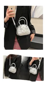 Close-up of silver quilted shell bag showing metallic texture and rhombic stitching details