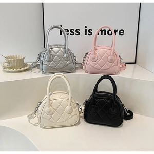 Multiple colors of quilted mini Boston bags with top handles and detachable straps