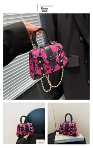 Detail of rose red snakeskin mini bag with gold rivets and elegant chain strap