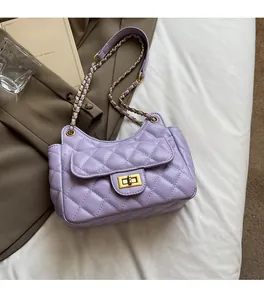 Close-up of lavender quilted shoulder bag with gold chain strap and metal turn-lock