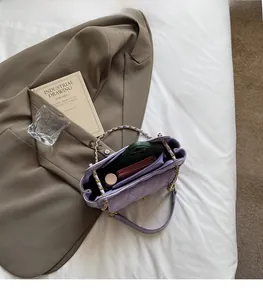 Detailed top view of the spacious purple quilted chain bag interior with its compartments