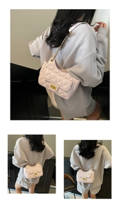 Detail of light pink quilted handbag featuring gold metal twist lock and chain strap
