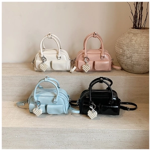 Collection of chic Boston bags in four colors with pearl heart charms and crossbody straps