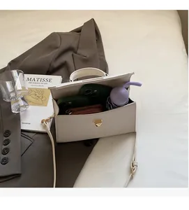 Detailed interior view of white pebbled leather bag showing large storage capacity