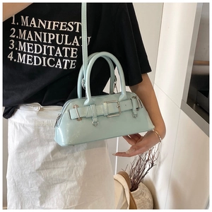 Détail du sac à main en cuir verni vert menthe avec boucle et poignée solide