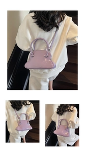 Detail of lilac glossy patent leather handbag with silver rivets and double handles