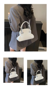 Detailed close-up of white wavy base handbag featuring silver hardware and matte finish