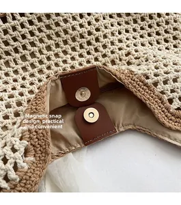 Detail of magnetic snap closure on handmade woven tote bag with leather attachment