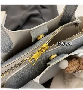 Detail of high-quality lychee texture leather with gold metal zipper and magnetic closure