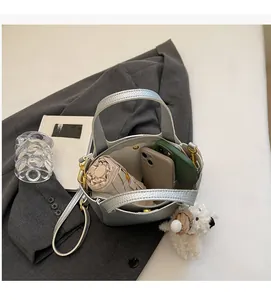 Interior view of silver bucket bag with lychee texture showing large capacity storage