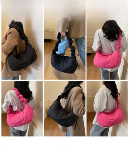Model showcasing quilted dumpling bags in black and pink with pleated shoulder straps
