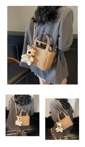 Detailed view of camel lychee pattern bucket bag with cute plush bear charm and strap