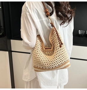Detail of hand-woven crochet bag with contrast stitching and decorative wood beads