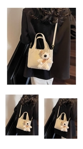 Detail of lychee pattern leather bucket bag with cute bear charm and golden hardware
