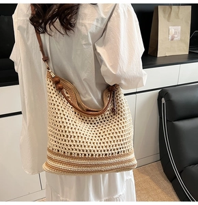 Detail of hollow woven shoulder bag featuring natural wooden beads on the strap