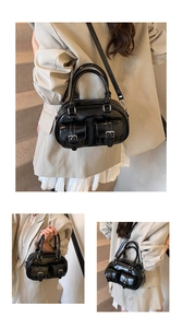 Detail of black glossy bowling bag with silver buckles and adjustable shoulder strap