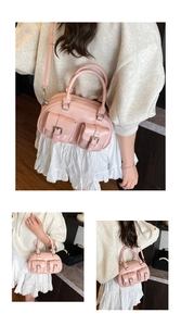 Detail of pink patent leather bowling bag showing silver hardware and decorative pockets