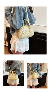 Detail of yellow lychee leather bowling bag with FOR YOU bow ribbon and sturdy handle