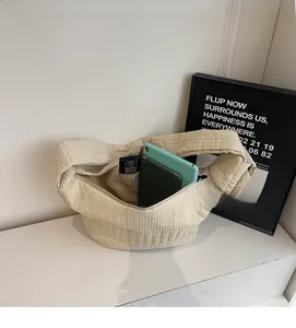 Spacious interior of off-white nylon crossbody bag holding a large tablet device