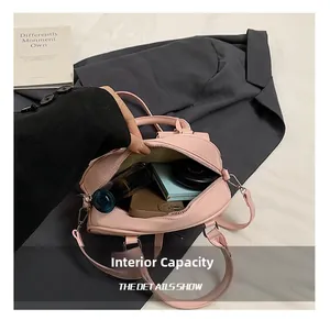 Detailed view of pink bowling bag interior showing phone and cosmetics storage