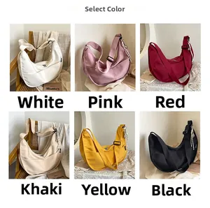 Minimalist canvas crescent crossbody bag shown in six colors with wide shoulder straps