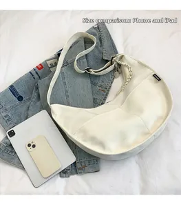 Ivory white hobo bag shown with a smartphone and tablet to demonstrate its large capacity