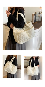 Quilted off-white tote bag detail showing leaf pattern stitching and spacious front pockets