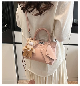 Détail du sac à main vintage rose avec ours et mini pochette porté par un mannequin
