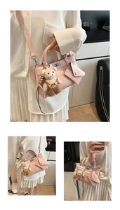 Detail of pink envelope crossbody bag with cute plush bear and mini pouch accessory