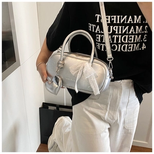 Silver bowling handbag for women with white lace bow and heart charm, trendy crossbody bag.
