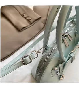 Détail du sac à main vert menthe avec finitions argentées et double fermeture éclair