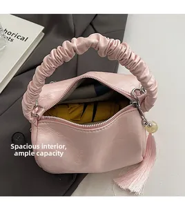 Interior view showing the spacious yellow lining and capacity of the pink pleated bag