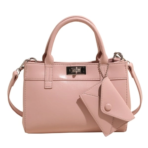 Stylish soft pink structured tote bag with silver twist lock and mini envelope charm