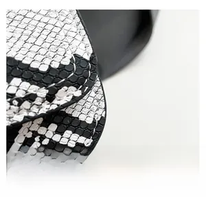 Close-up of black and white python print leather texture and neat stitching details