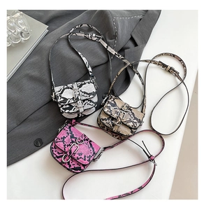 Detailed view of mini saddle bags with snake skin patterns in pink, brown, and black