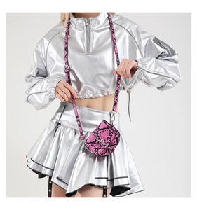 Mini pink and black snake pattern crossbody bag with silver clasp shown on a model