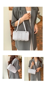 Close-up of a white beaded crossbody bag featuring a rectangular woven pearl design